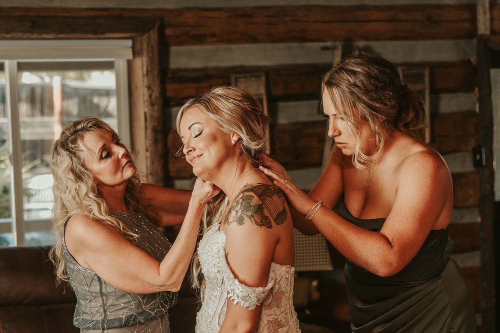 Jessica’s final touches lace gown, delicate jewelry, and joyful anticipation with bridesmaids and mom of bride. Yakima wedding photographer