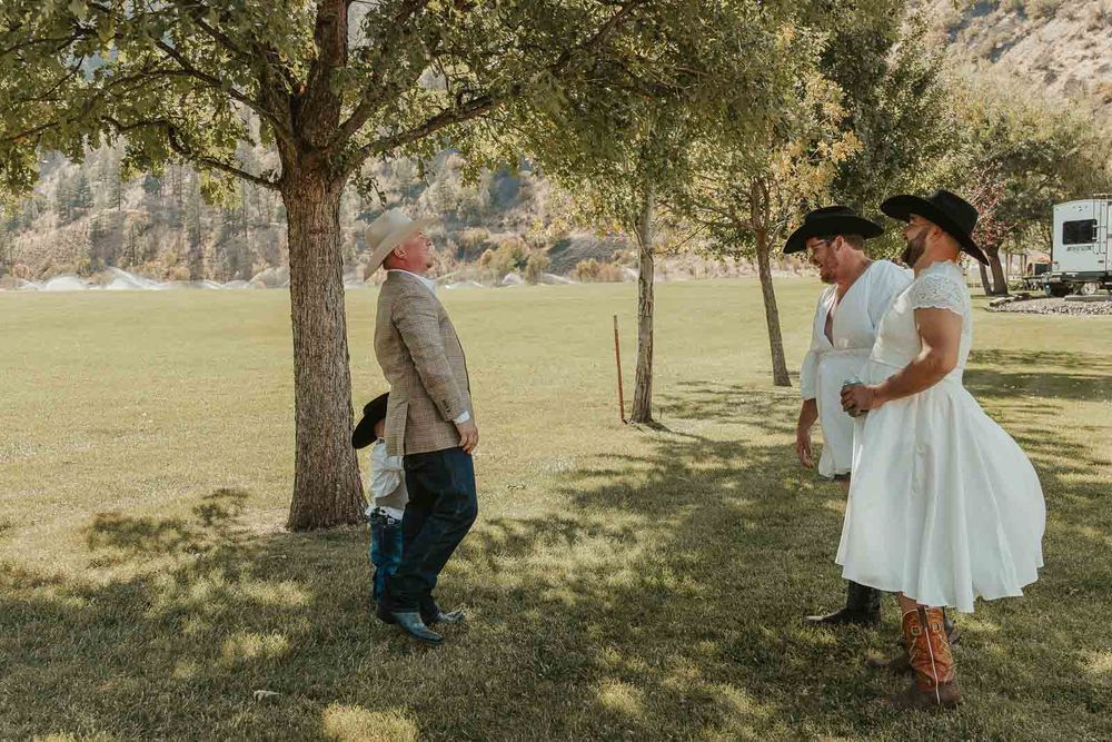 Groom Cody in a plaid jacket and cowboy hat at the American Homestead. Photographed by a Washington wedding photographer prank first look