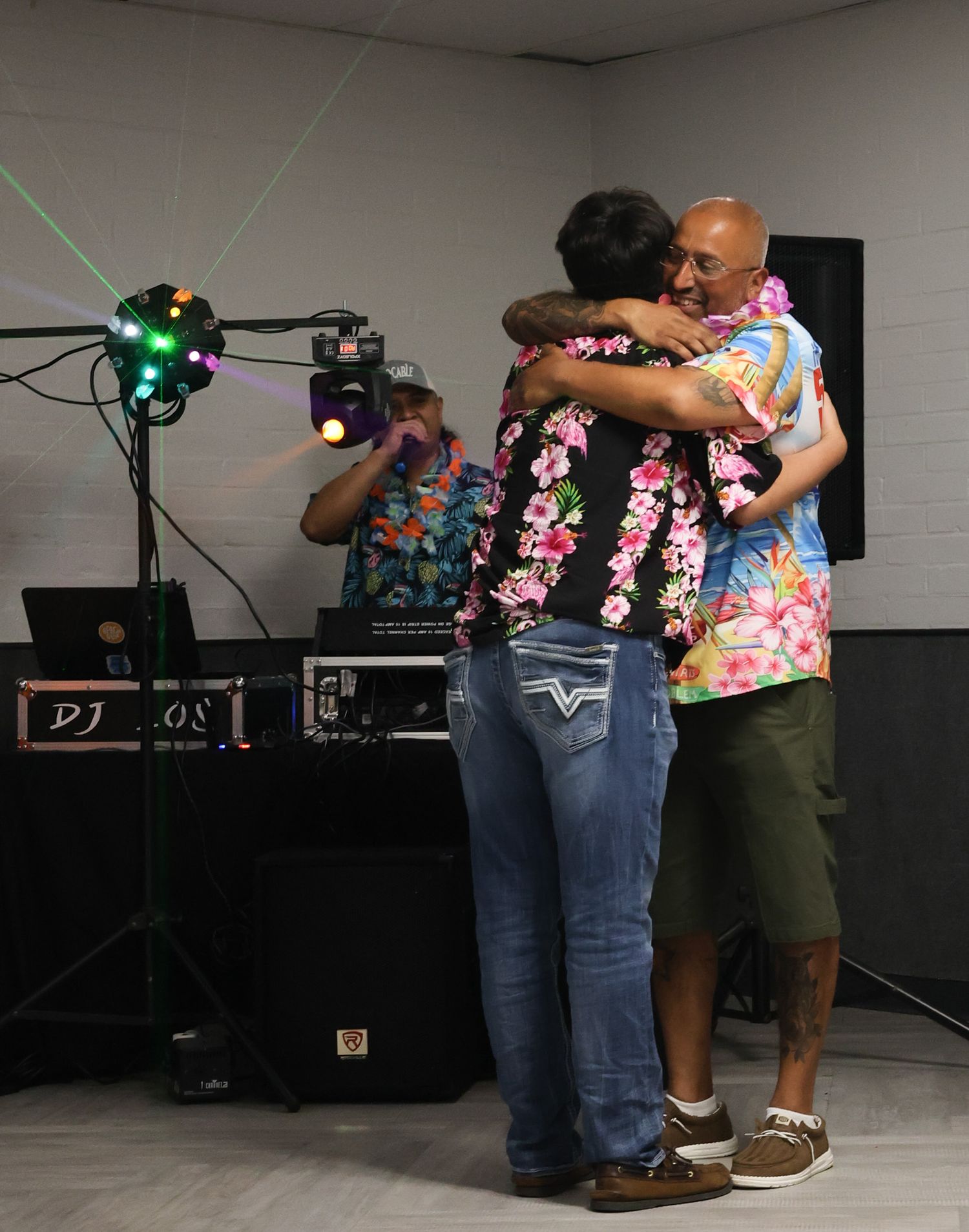 Two people dancing together in a studio with lighting equipment visible in the background.