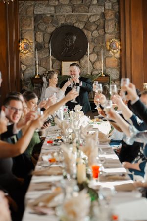 dinner table toasting bride and groom