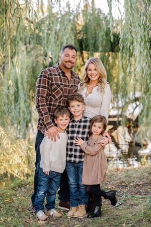 family photo in front of willow tree