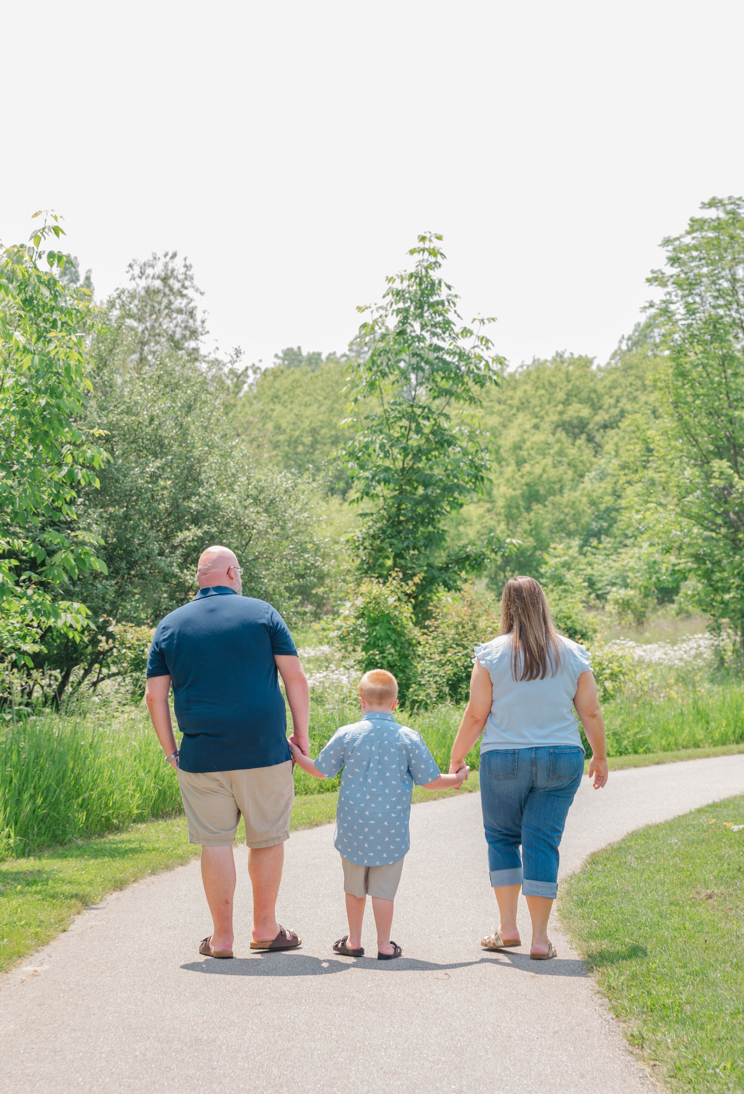 family walking away holding hands