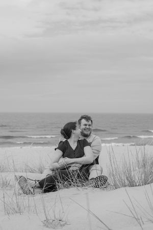 couple sitting on sand at beach