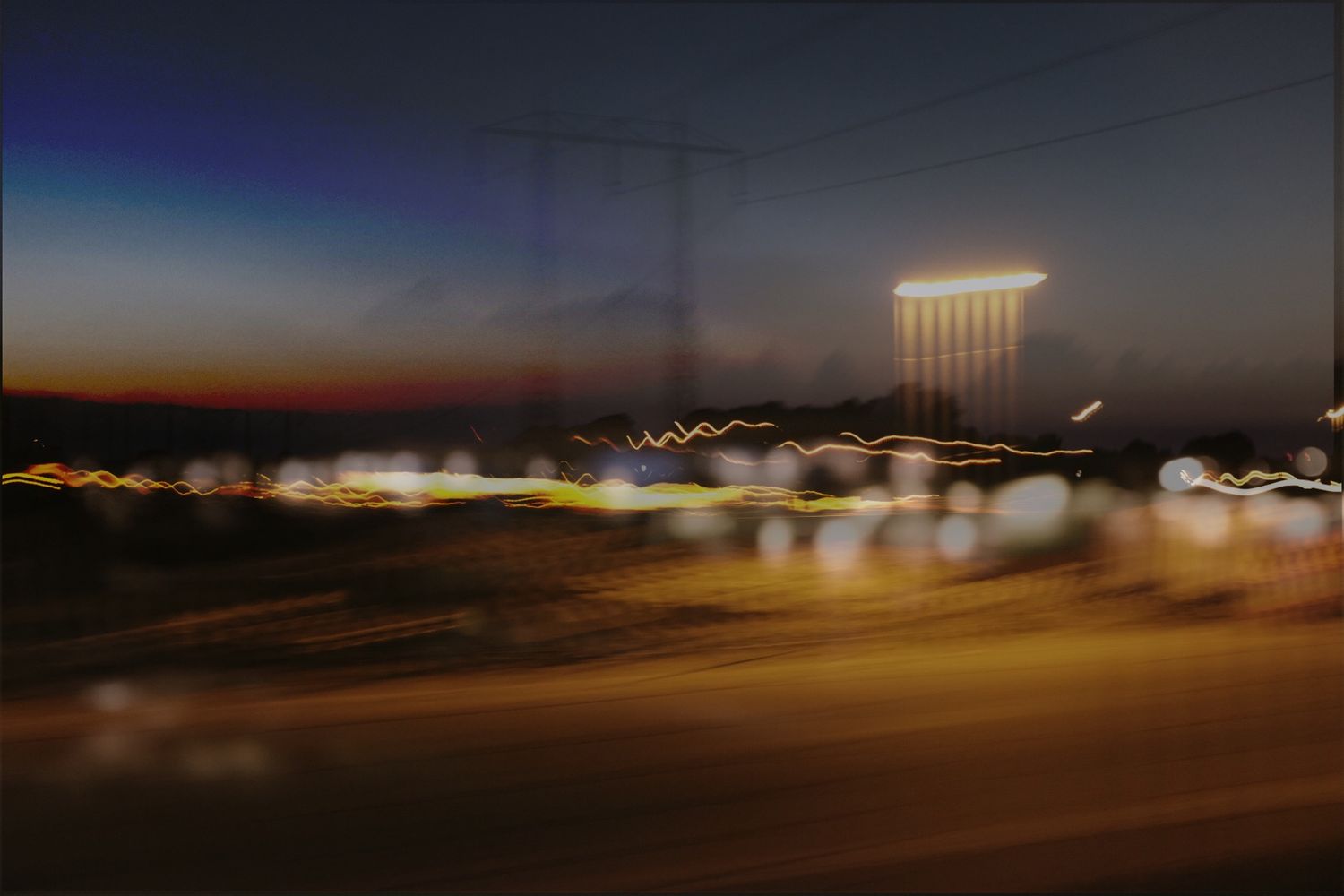 Night time photograph in ICCm technique. Lights, electrical wires and poles.