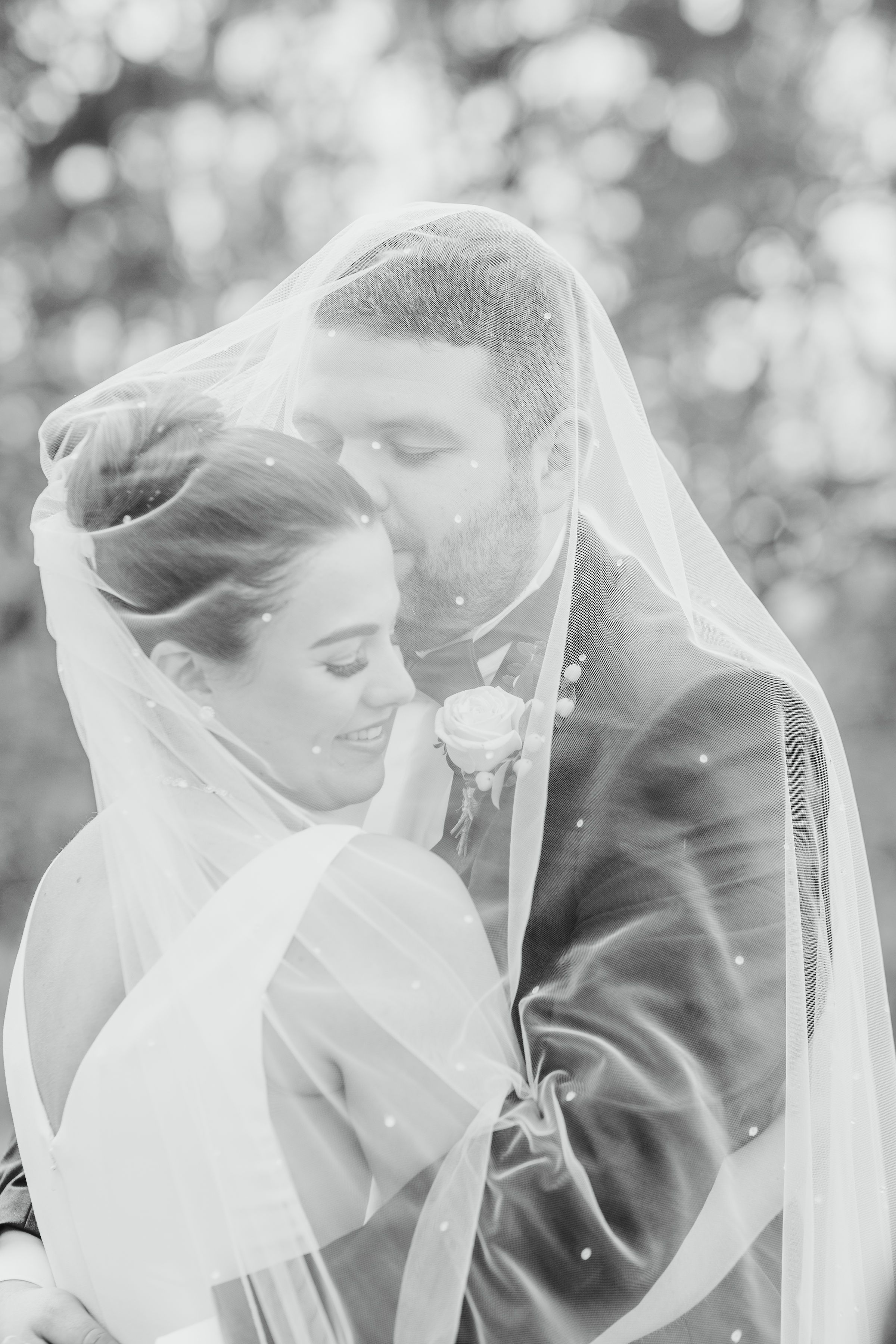 groom kissing  brides forehead under the veil at The Mill at Hoveringham