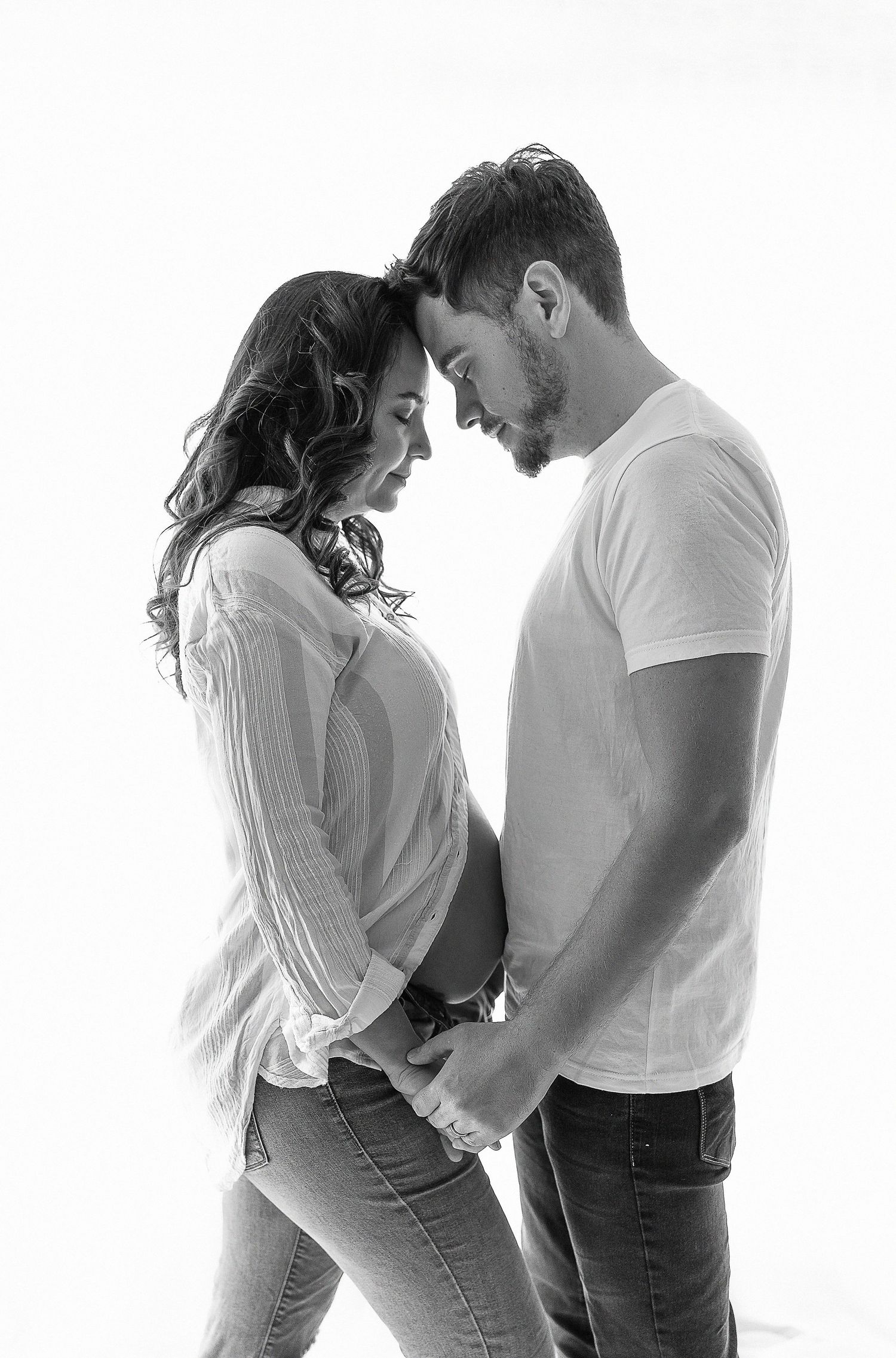 Black and white portrait of family sharing tender moment together.
