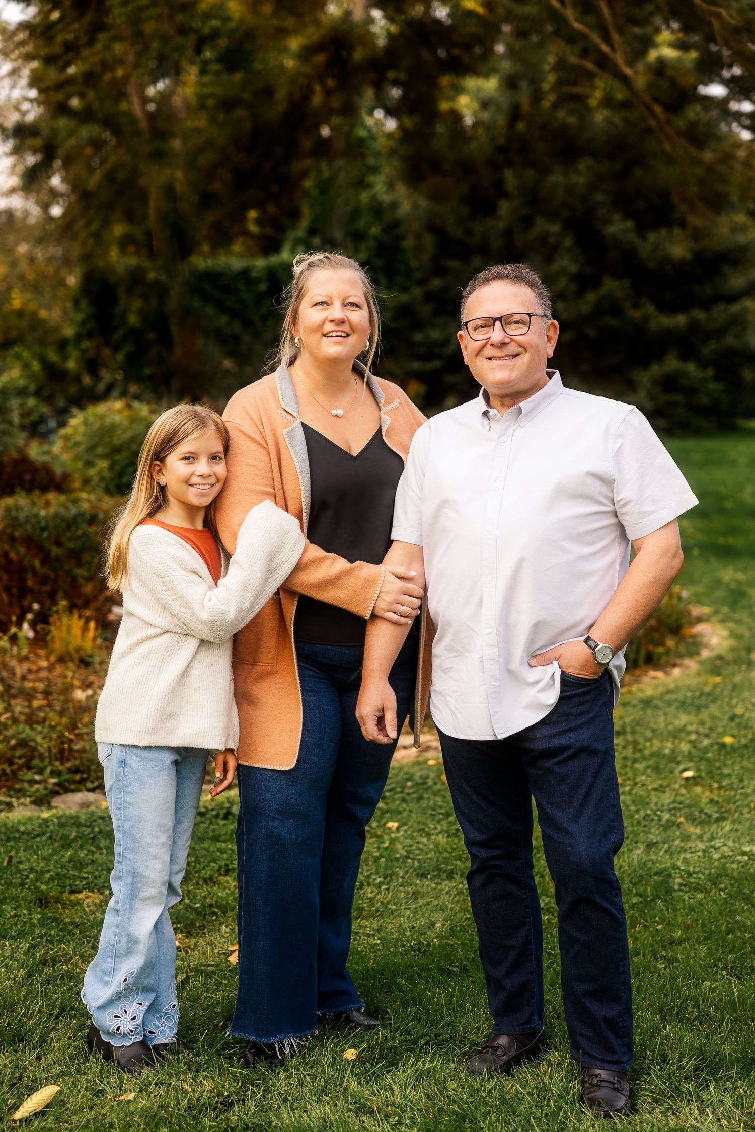 Family portrait outdoors with autumn foliage in background. Novi Northville Portrait Photographer