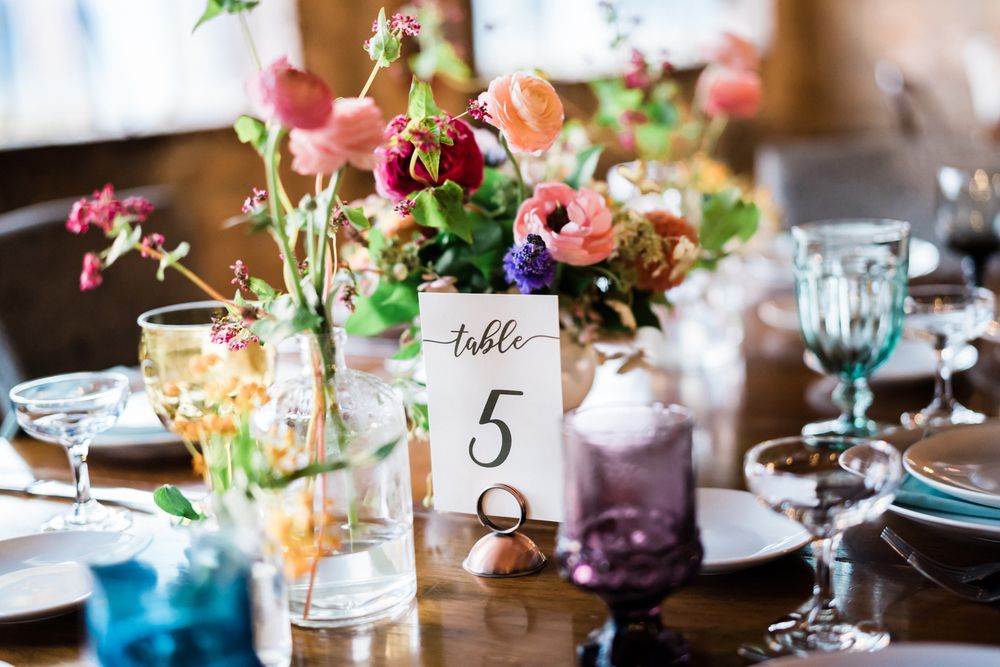 Colorful wedding reception flowers and centerpiece decorations at Salvage One in Chicago, Illinois.