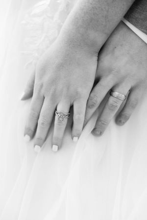 Close-up series of hands displaying engagement and wedding rings on white background.