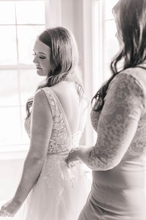 Several soft-focus black and white images showing preparations in white wedding attire.