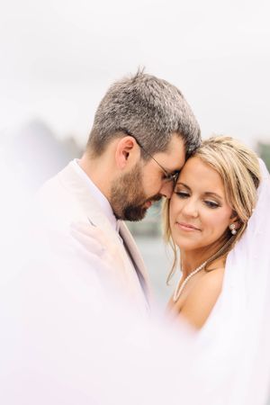 Intimate close-up portrait of newlyweds sharing tender moment together.