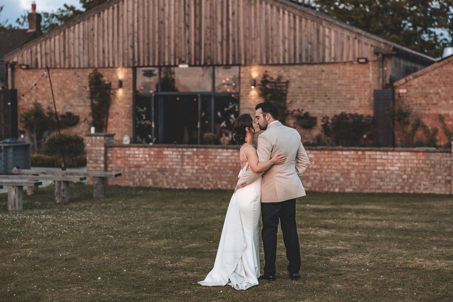 A relaxed couple moment enjoying the large space of their wedding venue for portraits