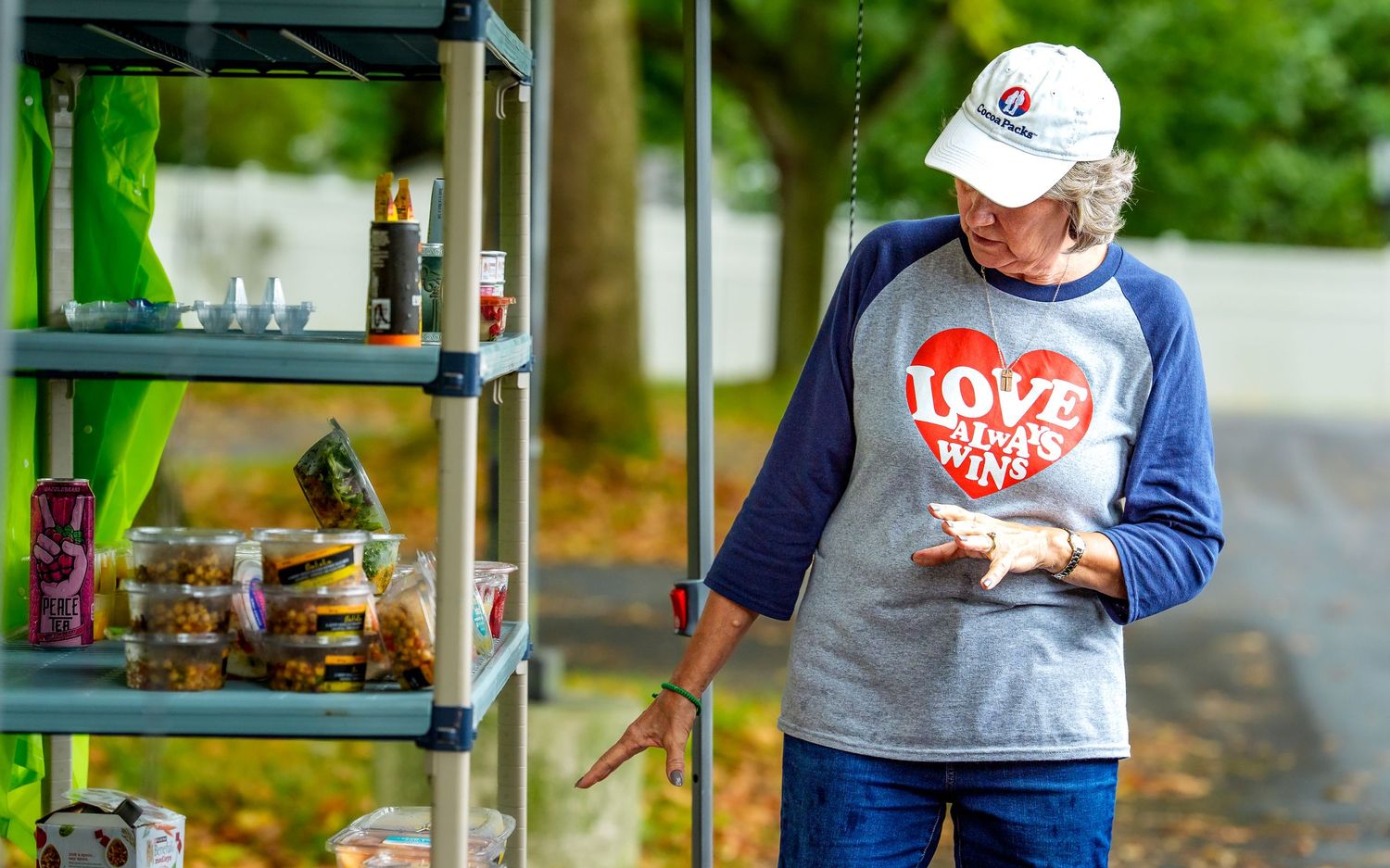 Cocoa Packs volunteer in a Love Always Wins shirt sorting donated food, by Deanna Fox, SportsFox Photography, based in Hershey PA
