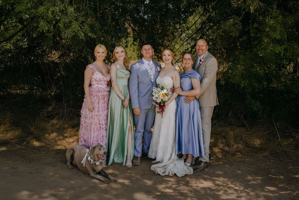 WEdding photo of family of 6 wearing florals and dog