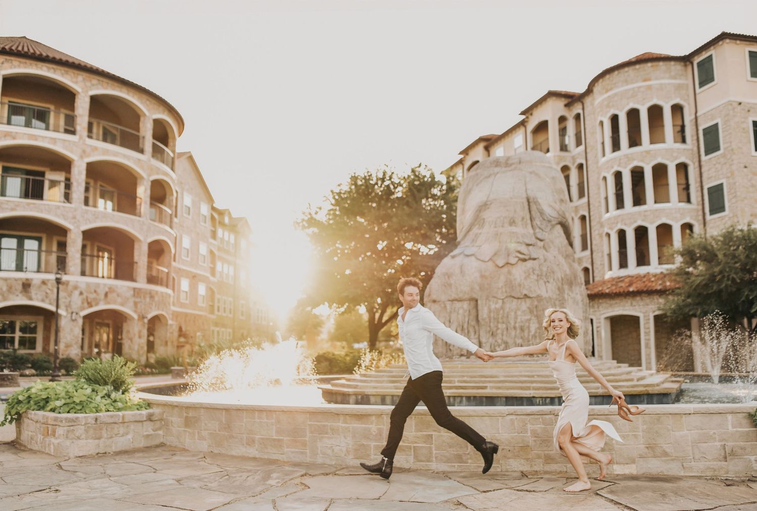 newlyweds walk candidly in the sunset during their cocktail hour at the laurel wedding venue