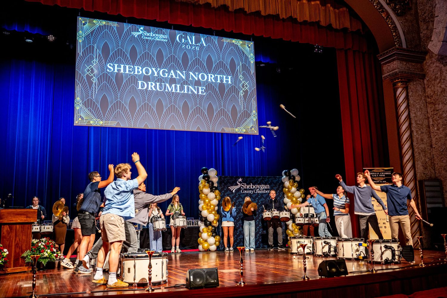 Sheboygan North Drumline performing on stage at a gala event.