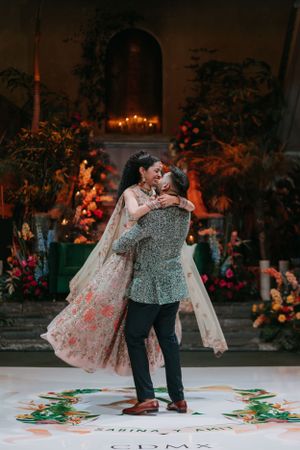 Couple dancing together on decorated floor during wedding celebration.