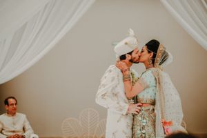 Intimate wedding ceremony moments captured under soft white draping and lighting.