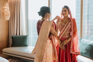 Candid moments of wedding preparation in a modern room with natural lighting.