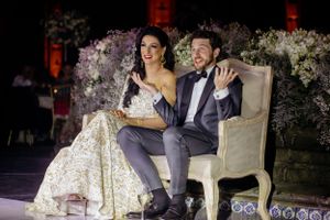 Elegant wedding reception scene with floral decorations and mood lighting.