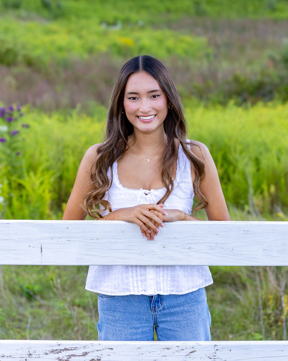 High school senior from Weston High School pose for yearbook photos in a wildflower field.  Serving Wayland High School and Concord Carlisle