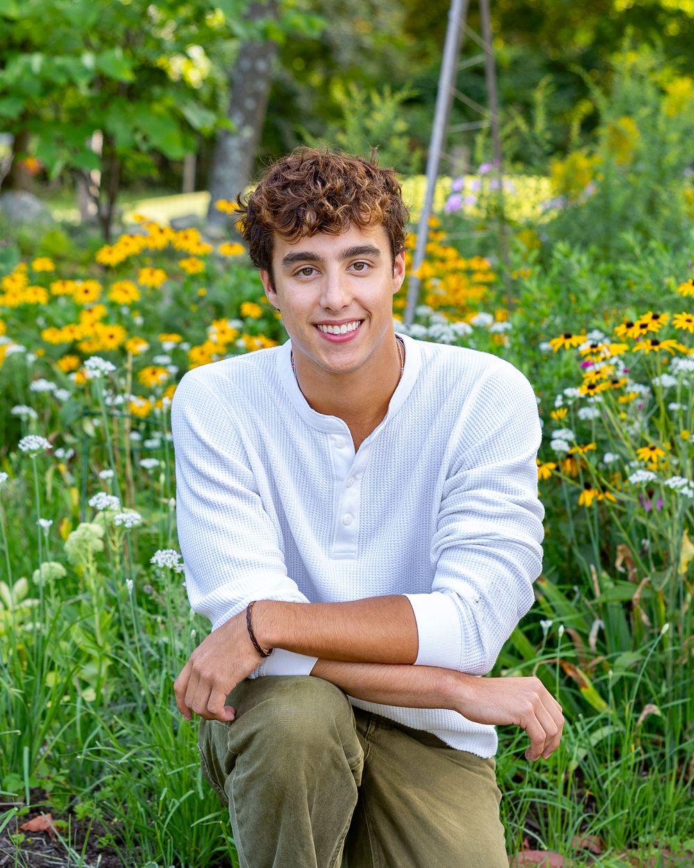 High school senior from Lincoln Sudbury pose in park with flowers for yearbook photos. Serving Weston High School, Wayland, Concord Carlisle