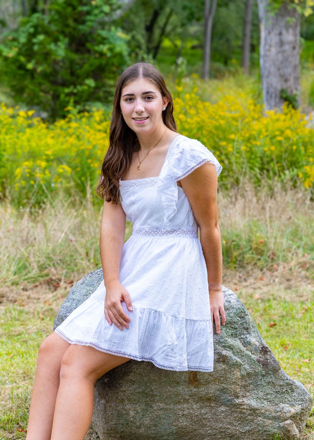 Senior portraits for Nashoba High School poses for yearbook photos in a wildflower field.  Serving Weston High School & Wayland. in Concord