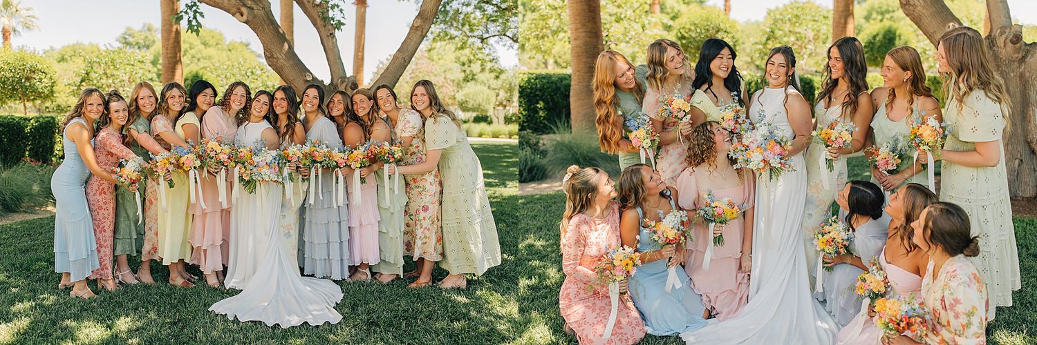Bridal party in mismatched floral dresses posing outdoors under trees with bouquets at a sunny garden wedding.