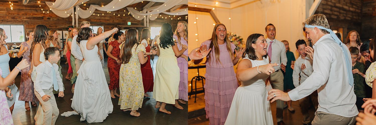 Guests dance joyfully at a wedding reception in a rustic venue decorated with string lights and streamers.