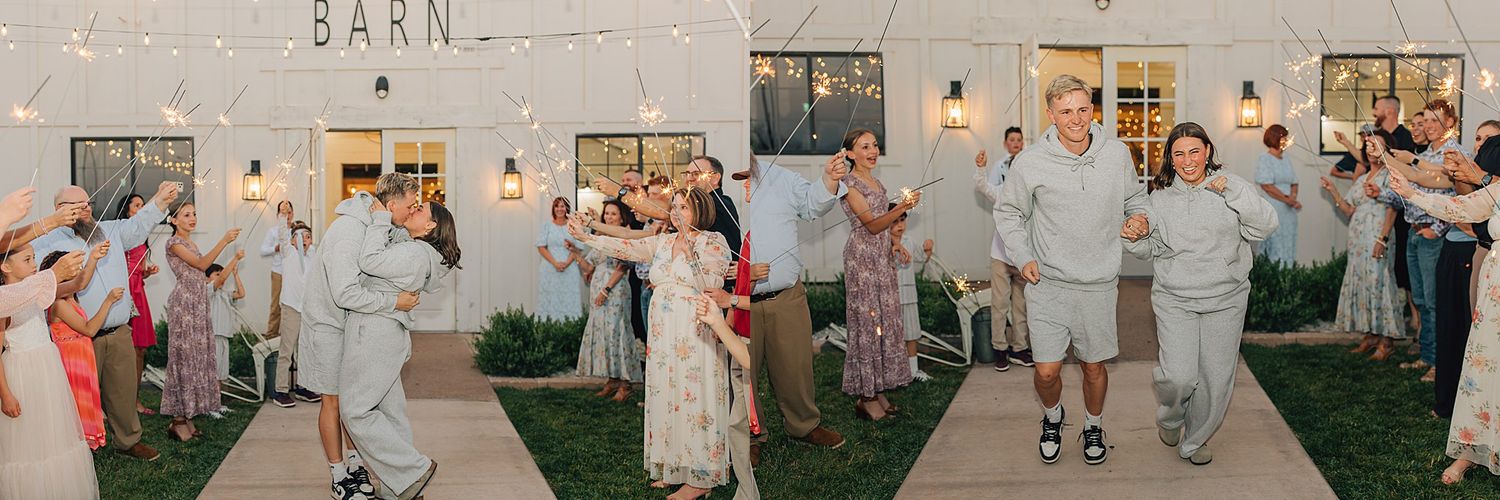 Joyful wedding couple exits barn venue through cheering guests under string lights at outdoor evening reception.