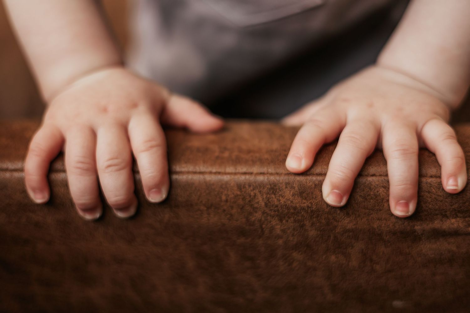 Close-up of small baby hands  showcasing delicate fingers and soft skin| Professional Milestone Sessions for Baby