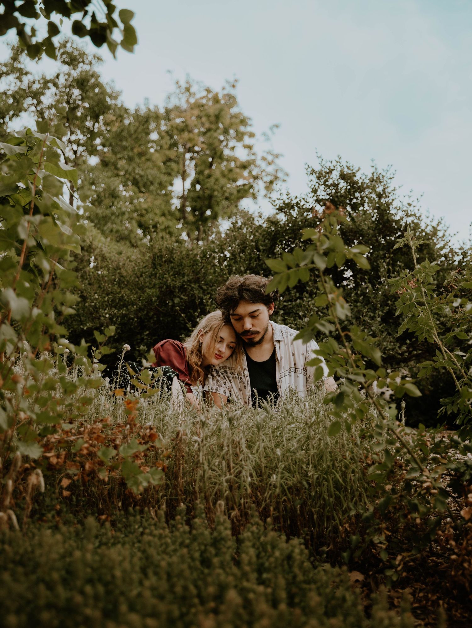 Couple sits and rests on each other for candid couples, engagement photos, elopement, and cinematic photos in Denver, Colorado