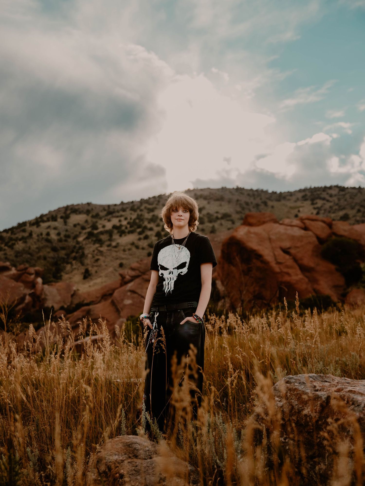 Boy stands and poses for senior photos, cinematic, mountain, and portrait photos in Morrison, Colorado outside and in nature