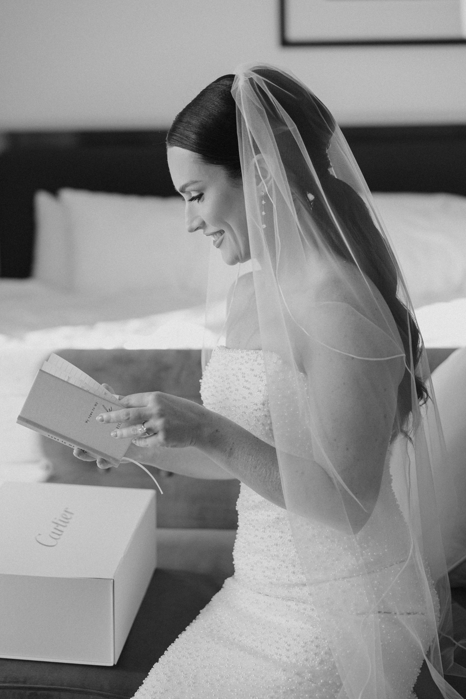 Artistic bridal portrait showing the back of a wedding dress and veil, captured during a wedding day portrait session.