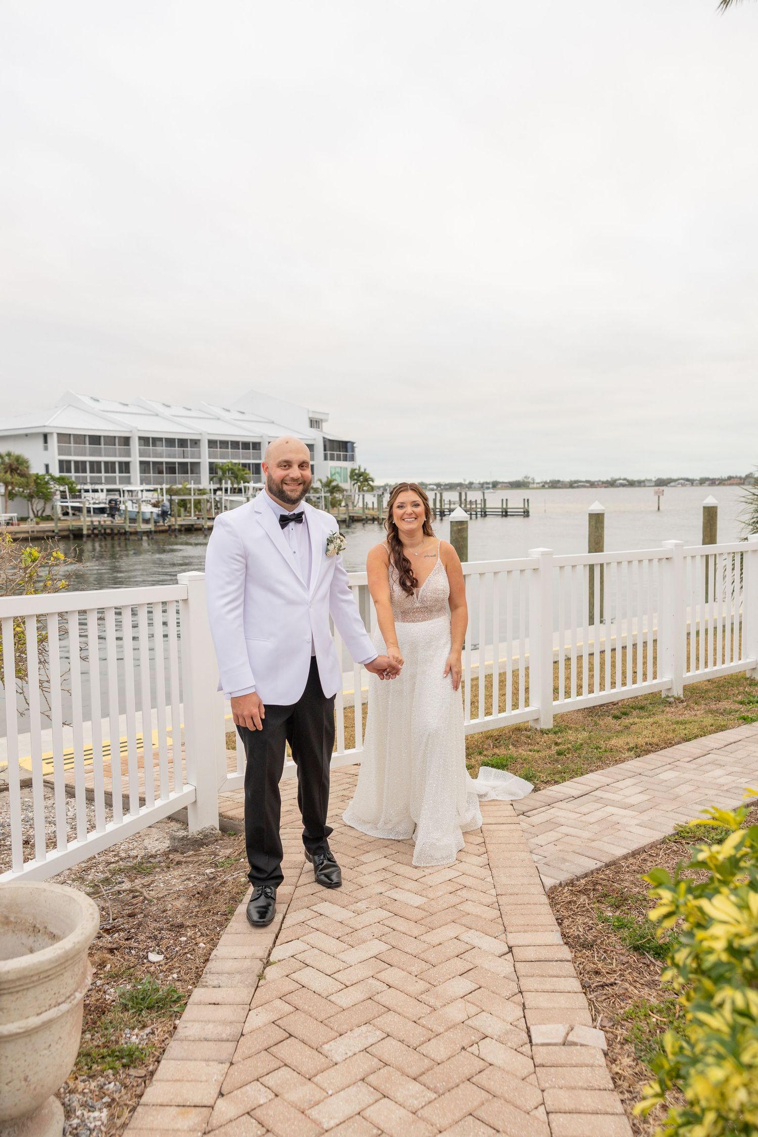 Bride and groom embracing on the beach during a wedding portrait session.
