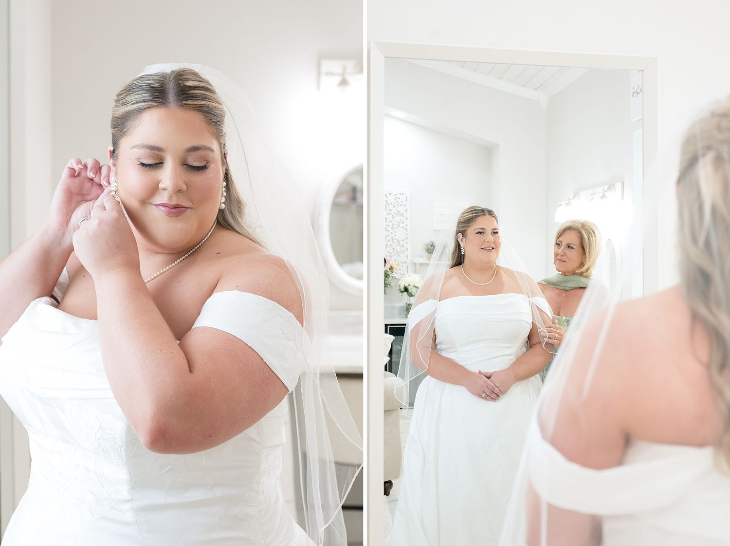 Bride in white off-shoulder gown adjusting earring while assistant helps with veil in bright dressing room.
