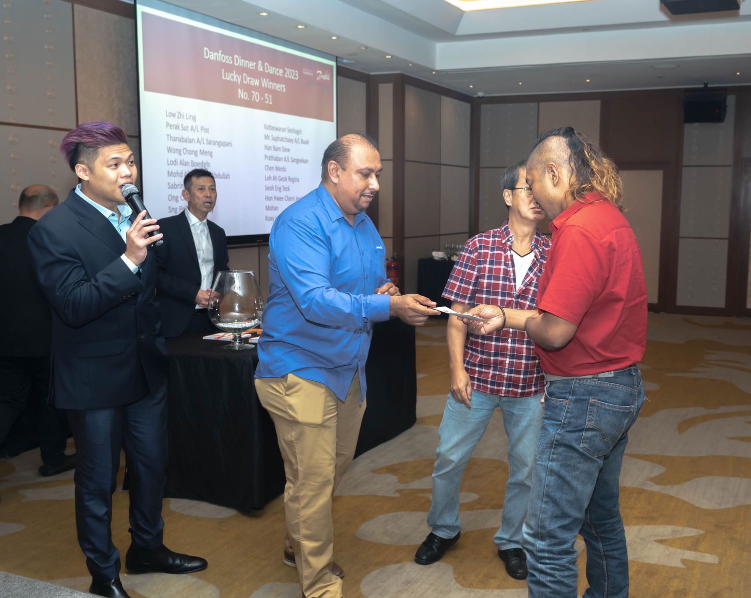Business professionals exchanging handshakes during an awards or recognition ceremony.