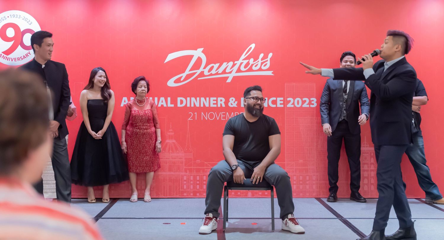 People performing on stage during Danfoss annual dinner and dance event.