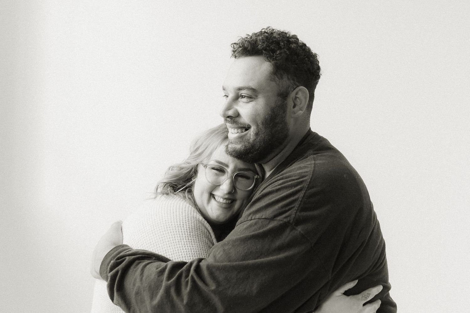 Intimate black and white portrait of couple embracing.