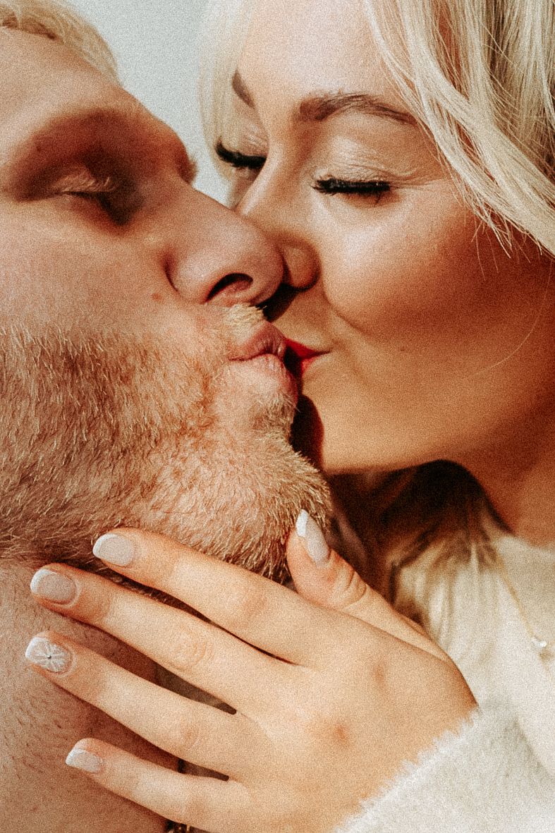 Intimate close-up of romantic couple sharing a kiss.