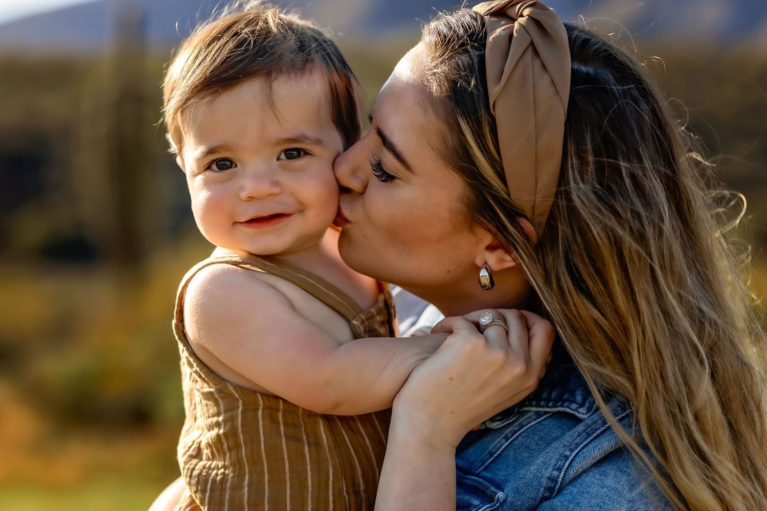 Sweet outdoor portrait showing affectionate moment in warm sunlight mommy and me photo session in Cave Creek Arizona
