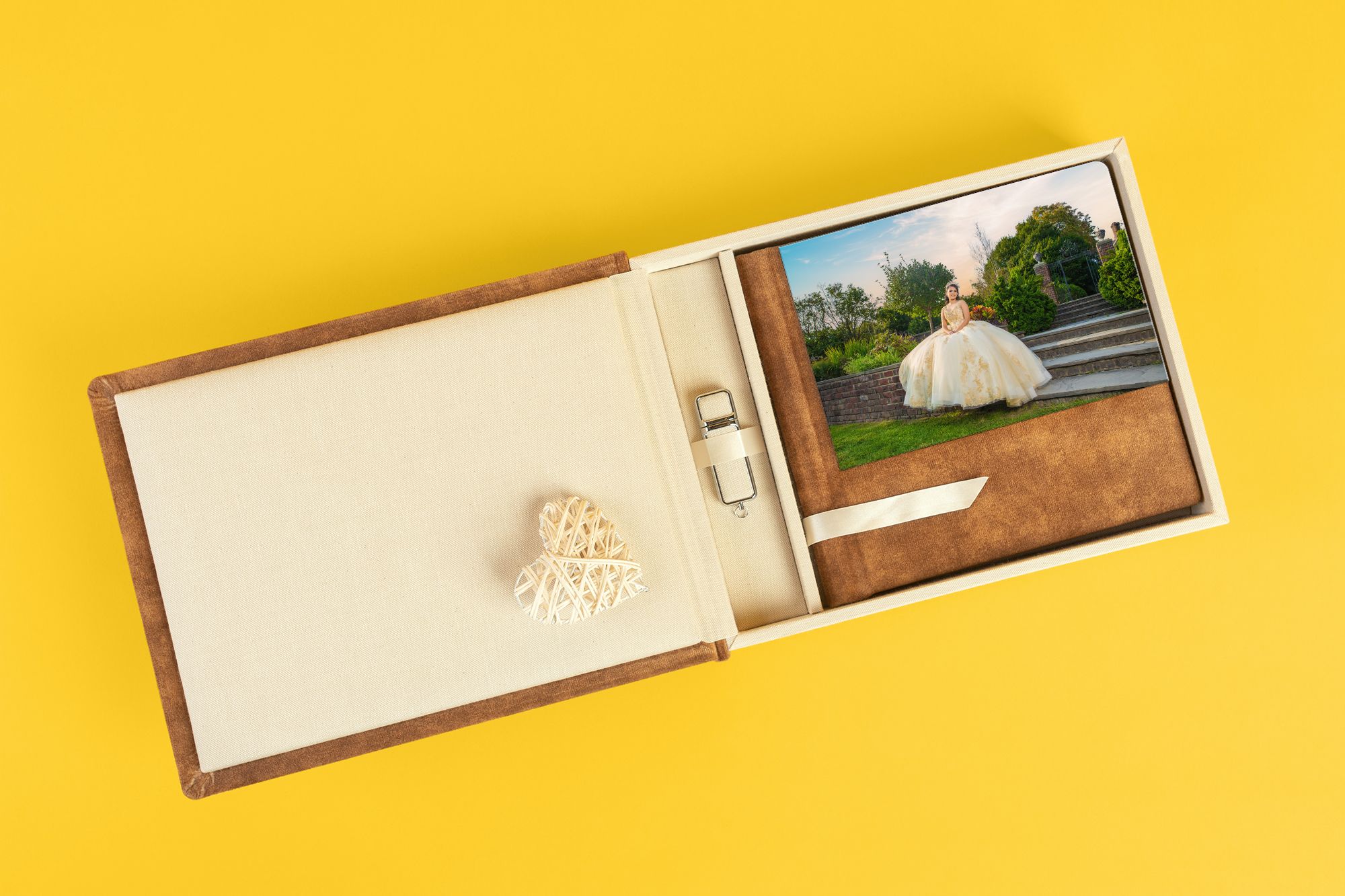 Brown photo album with prints and decorative elements on yellow background.