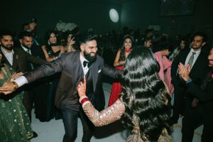 Guests dancing and celebrating at an elegant wedding reception.