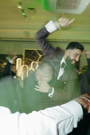 A celebratory moment captured with motion blur at an indoor wedding reception.