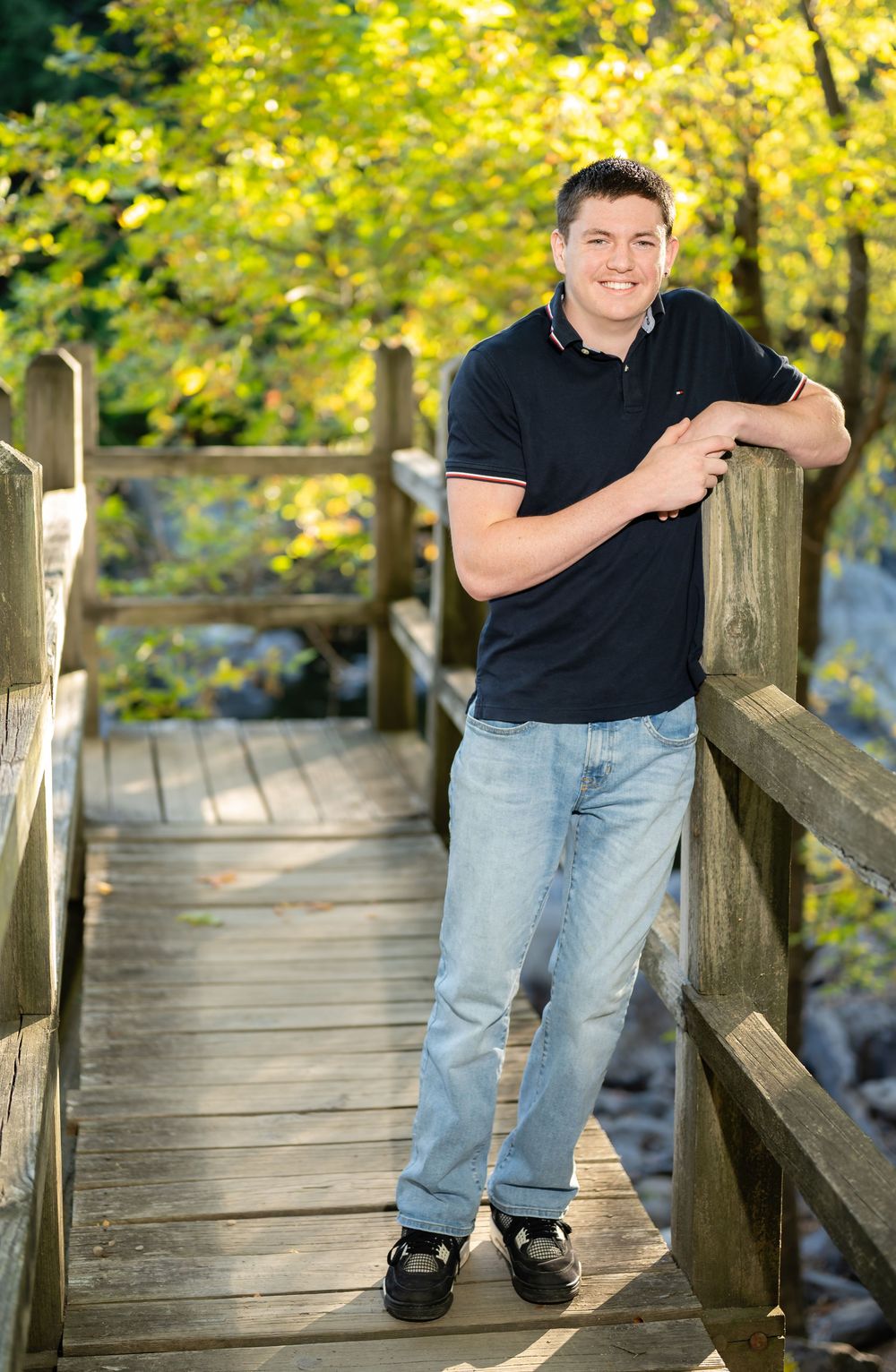 A series of four photos on a wooden boardwalk surrounded by autumn foliage in natural lighting.
