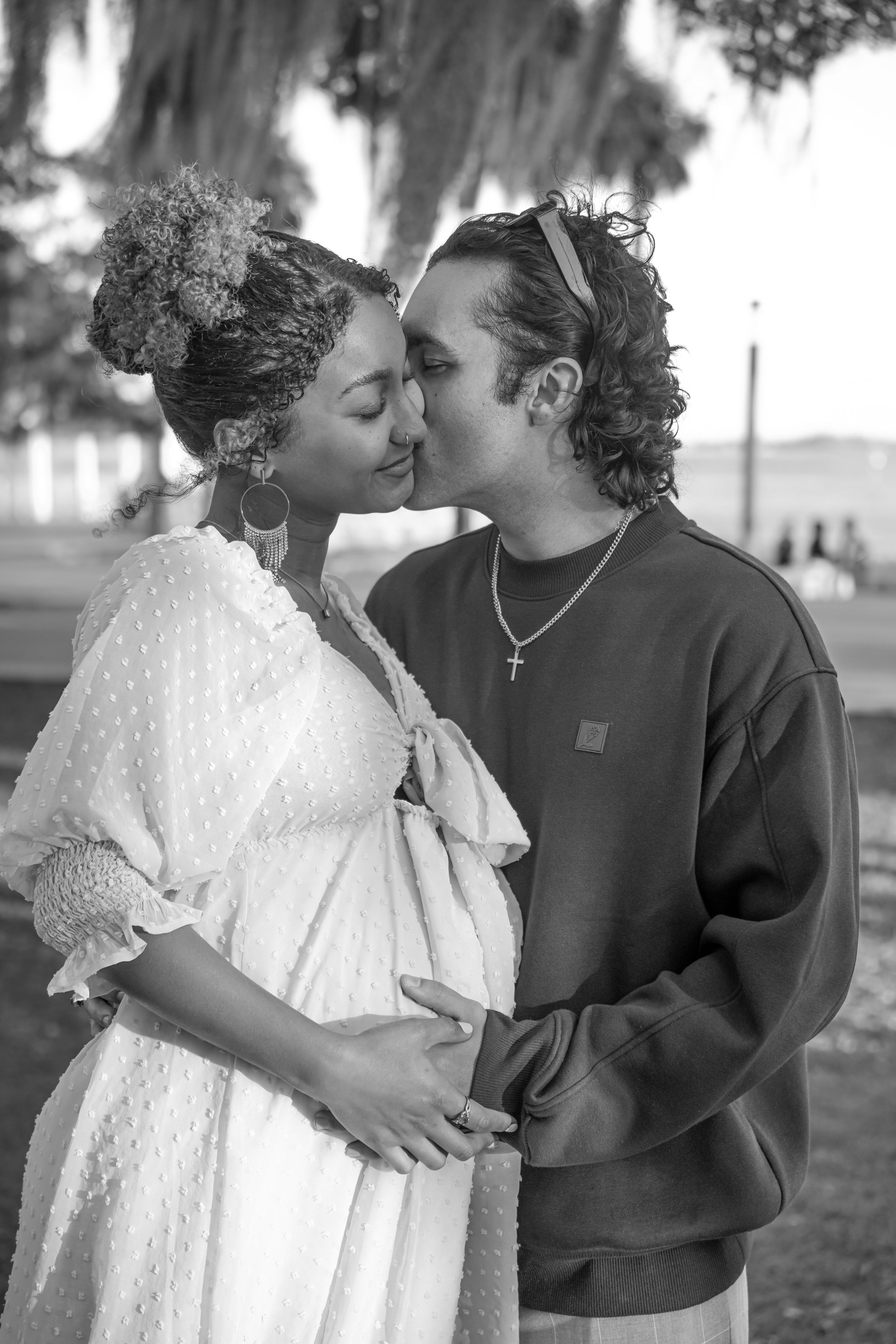 Romantic maternity portraits taken in a natural outdoor setting.