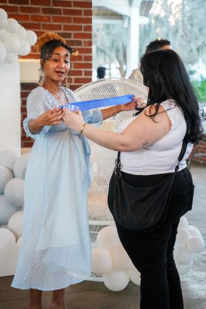 Candid moments at a celebration with guests in white and black attire.