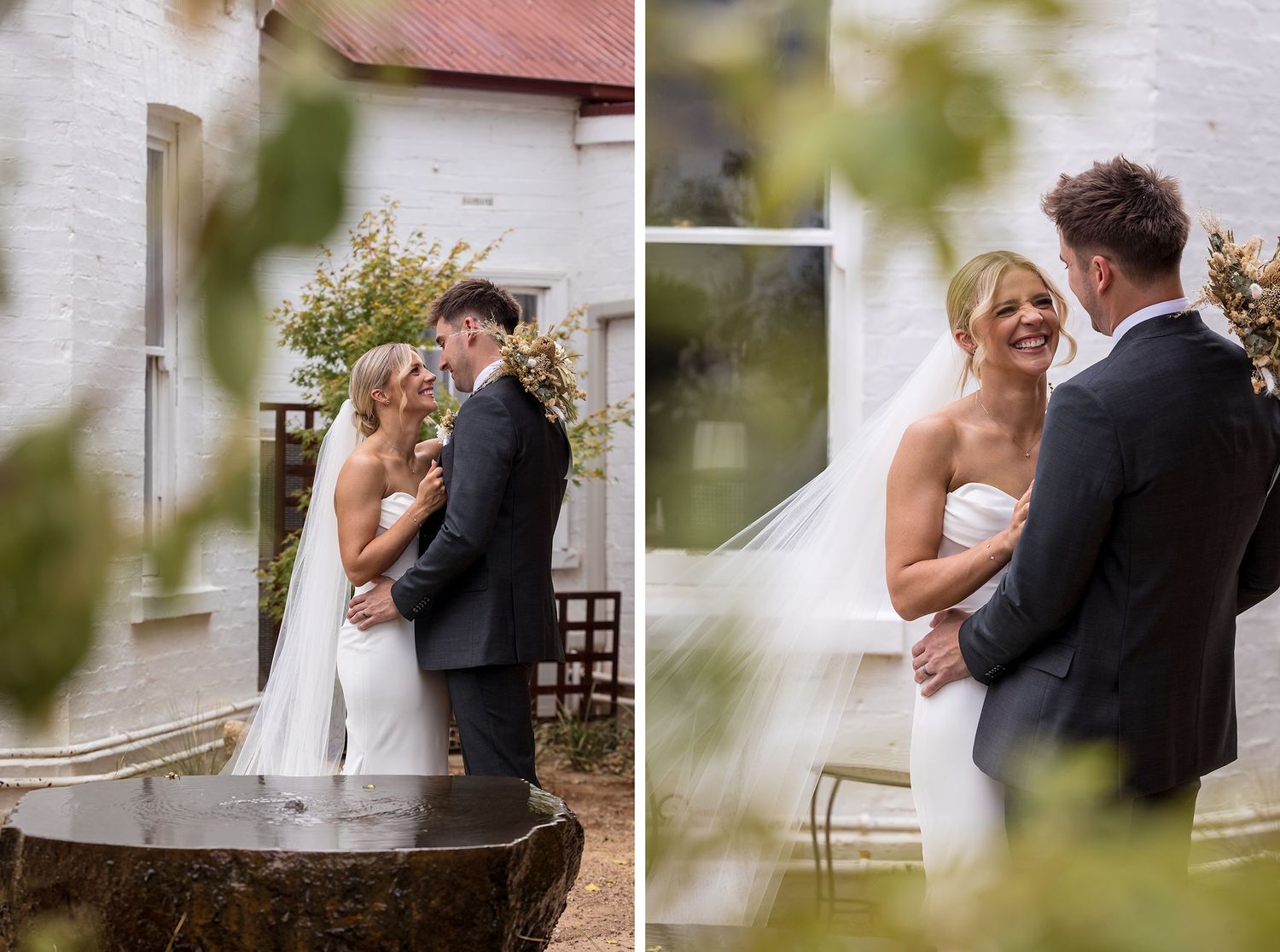 A tender outdoor moment during a wedding celebration at a rustic venue with white walls and natural greenery.