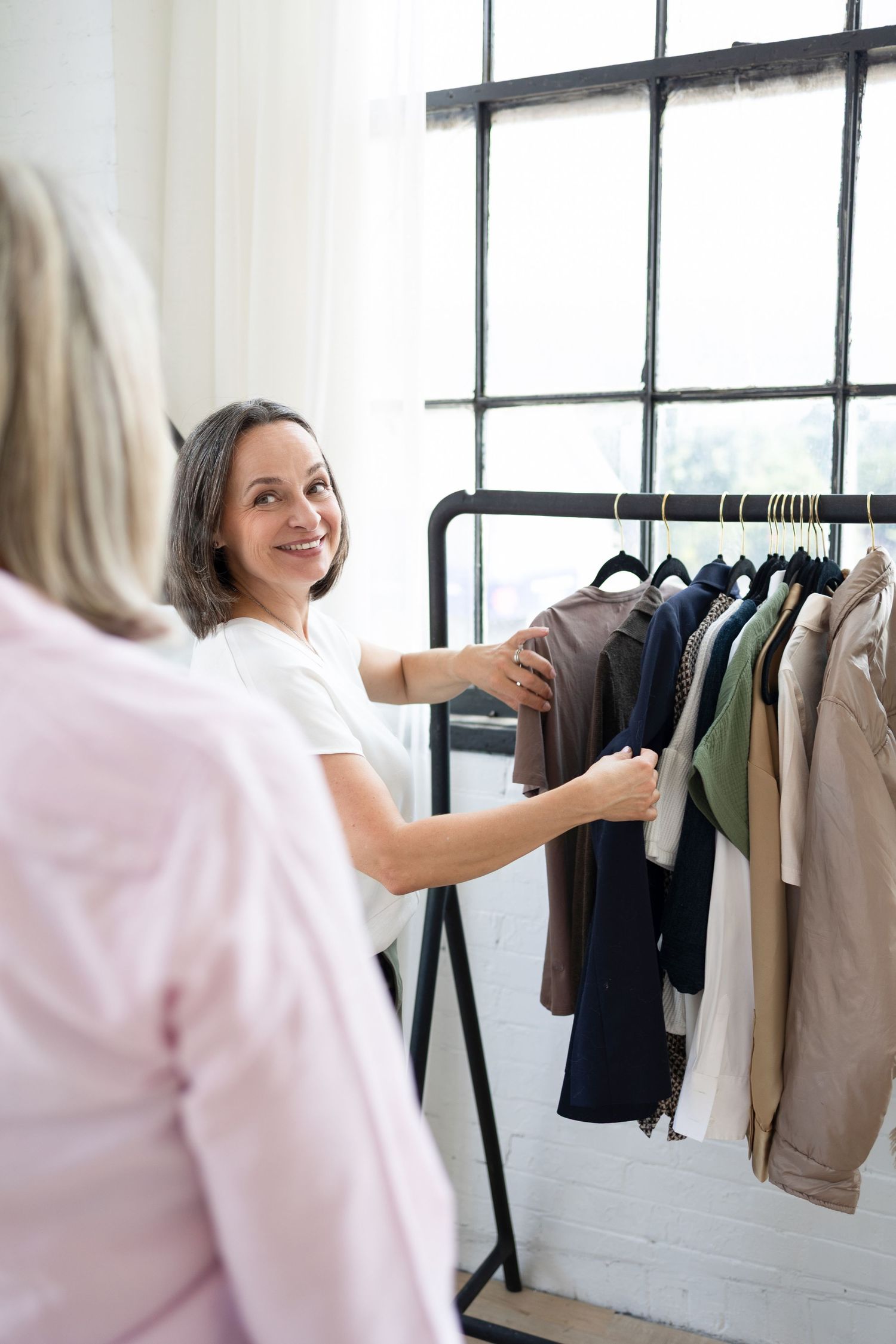 image consultant helping client choose clothing during a branding photoshoot in London Ontario