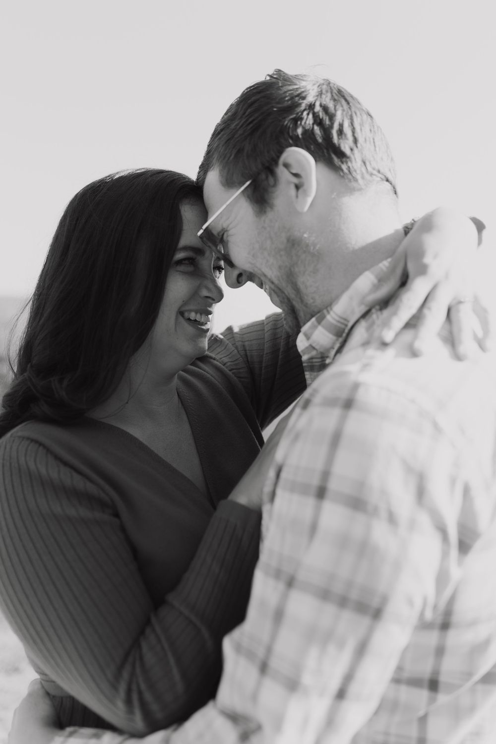 A romantic black and white photo sequence showing a couple embracing and sharing intimate moments.